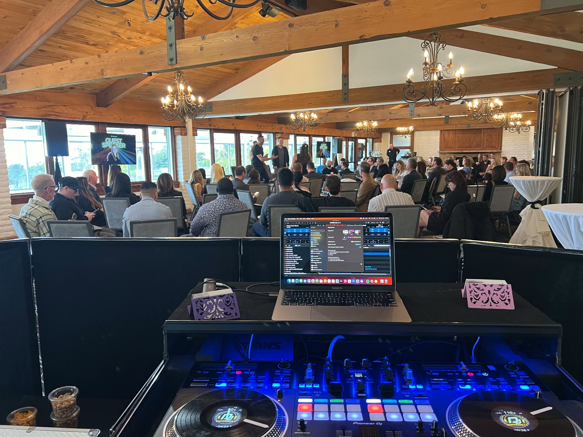 Corporate guest speaker event with a DJ setup and engaged audience